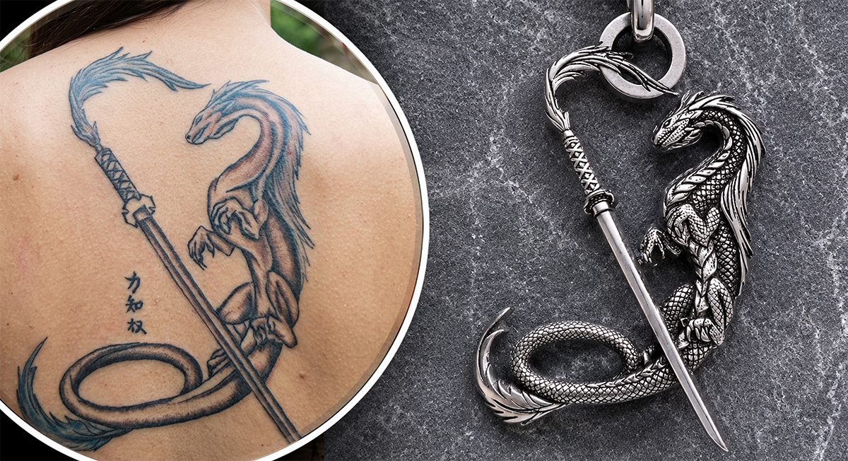 Dragon tattoo on skin and dragon-themed sword pendant on a dark surface